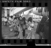 Undocumented immigrants boarding airplane in Los Angeles for deportation to Mexico City, 1976