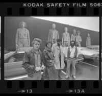 Muralist Kent Twitchell and three of his subjects, Marta Chaffee-Stang, Alonzo Davis and Oliver Nowlin, standing before "Six Los Angeles Artists" mural, 1980