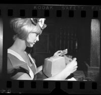 Waitress completing a credit card transaction in Los Angeles, Calif., 1970