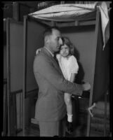 Buron Fitts and daughter voting at polling station, Los Angeles, 1929-1933