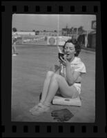 Second baseman Bernice Maxson applies make up on the field, Boston, 1936