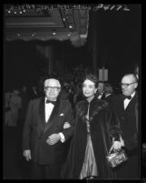 Actress Joan Crawford on the arm of Louis B Mayer at the "Torch Song" movie premiere in Los Angeles, Calif., 1953