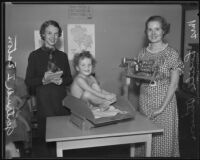 Lucille C. Stinson and Gertrude I. Eaton assist at the Mothercraft Clinic, Highland Park, 1935