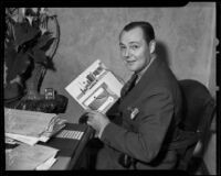 Actor Charles Ray holding drawing, Los Angeles, 1935