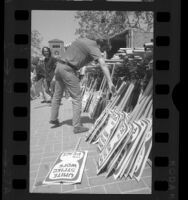 USC students picking up picket signs for anti-war march, 1970