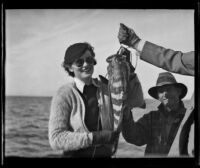 Frank Seebold smiles as Louise Whitney proudly shows off a fish she caught in the Gulf of California, Mexico, 1935