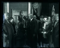 Mayor George Cryer flipping the switch to initiate new Wilshire Blvd. lighting system, Los Angeles, 1928