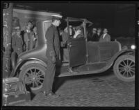 Police dusting for fingerprints in a Ford coup, possibly related to the Hickman kidnap and murder case, Los Angeles, 1927