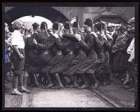 Shriner's Arab Patrol in costume in the midst dance with people looking on, Los Angeles, circa 1925