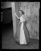 Los Angeles Junior League member, Elizabeth Bell, modeling evening gown designed by Galanos, 1955