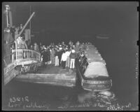 Crowd at Santa Monica Pier boards ferry, Irene, for a gambling barge on the ocean, 1939