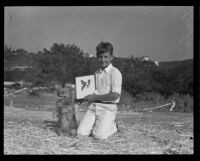 Leo Linkogel sitting with his dog, Buddy, at the second annual mutt show, Los Angeles, 1935