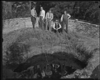 Deputy Sheriff Garrett Morford, Captain John Hanby, Deputy Sheriff Hearst, Captain Walter Allen, and Undersheriff Arthur Jewell drag a tar pit for the body of missing girl, La Brea Pits, Los Angeles, 1935