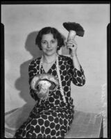 Mary Fiesel poses with gigantic mushrooms for the Los Angeles Times, Los Angeles, (1930-1935?)