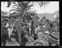 Close-up view of Rose Parade spectators on a residential street, Pasadena, 1930