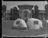 Girl points to the Battle of La Mesa marker at the Los Angeles Union Stockyards, Los Angeles, [1926-1939]