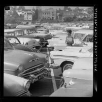 Mary Ann Harmon looking for her car in one of UCLA's packed parking lots, 1961