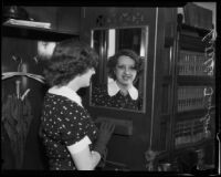 Estelle Taylor, actress, gazing into a mirror, Los Angeles, 1935