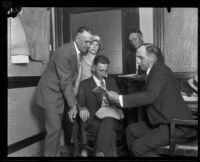 Detectives surround John D. Wiley and his wife as they confess to insurance fraud, Los Angeles, 1924