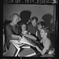 Frances Blend School for the Blind's Jean Kentle and Rosalie Calone passing out Braille books to students, Calif., 1963