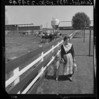 Dairy farmer Mrs. Arthur Atsma in an authentic Frisian costume with daughter in Dairy Valley, Calif., 1964