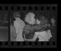 Dorothy Buffum Chandler (left), grandmother of Harry Brant Chandler, embraces Denise Hardré during the wedding of Hardré and Chandler, 1979