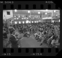 Jesse Jackson speaking to a large crowd and reporters at McKinley Baptist Church in South Central Los Angeles, Calif., 1984