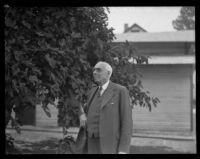 Dr. D. Willard Lyon, exchange professor at USC, standing outdoors, Los Angeles, 1930