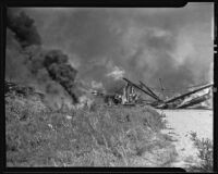 Fire burns the Compton Avenue wooden bridge, Los Angeles, circa 1939