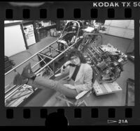 Drag racer, Shirley Muldowney in garage with her dragster, Calif., 1986