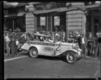 Captain Walter Wanderwell and Dorothy Dawn salute the camera from fleet car No. 2 while visiting Los Angeles, Los Angeles, [1932]