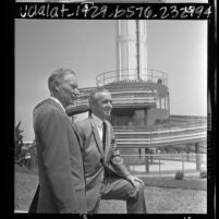 Marineland executives, Henry U. Harris and William F. Monahan standing before Marineland Sky Tower, Calif., 1966