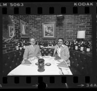 Restaurateurs, George Smith and Jimmy Ullo seated in booth at La Dolce Vita in Beverly Hills, Calif., 1976