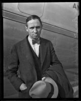 Reverend Everett Clinchy poses in front of an airplane, Los Angeles, 1935