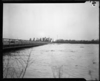 Bridge spanning the Los Angeles River during rainstorm flooding, Compton, 1927