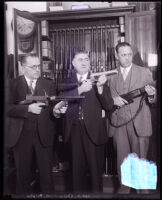 Police detective E. Raymond Cato and two other men posing with guns, Los Angeles, circa 1925