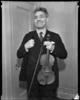 Fritz Kreisler holding his violin, Los Angeles, circa 1930-1939