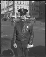 Officer Joseph Lundrigan saves a Christmas shopper from oncoming traffic, Los Angeles, 1935