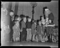 Children lined up to receive gifts from Santa Claus at the Elks Club, Los Angeles, 1938