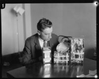 Los Angeles police sergeant Howard L. Barlow with fingerprint evidence collected from home of kidnapping and murder suspect William Hickman, 1927