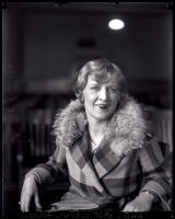 Edith Andrews seated in a courtroom alone during her divorce from film director Del Andrews, Los Angeles, 1928