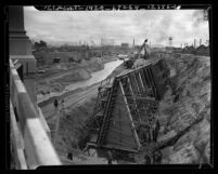 Workers building framing for concrete and digging during reconstruction of Los Angeles River, Calif., 1938