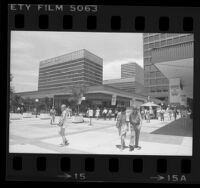 Shoppers at Century City Shopping Center which is decorated with 1984 Olympics banners, Los Angeles, 1984