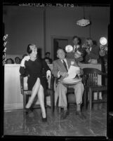 Actress Marilyn Monroe sitting in courtroom with her attorney Jerry Giesler during divorce from Joe DiMaggio, 1954