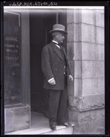 Full length side view of sheriff Martin Aguirre standing outside Judge Frank R. Willis' office