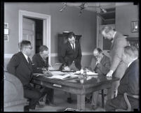 Hoaxer Andrew Roberts seated at a table with others, Los Angeles, 1924