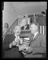 Actor Adolph Menjou looks over a copy of "The Conscience of a Republican [Conservative]," with Paul H. Talbert, 1960