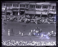 Elephant-shaped parade float proceeds as spectators watch during American Legion Parade, Long Beach, 1931