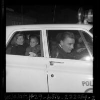 Patricia Lawford with daughter Sydney, in police car on way to airport after JFK assassination, Calif., 1963