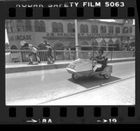 Ken Eacrett driving his solar-powered three wheel car on Santa Monica Pier, Calif., 1979